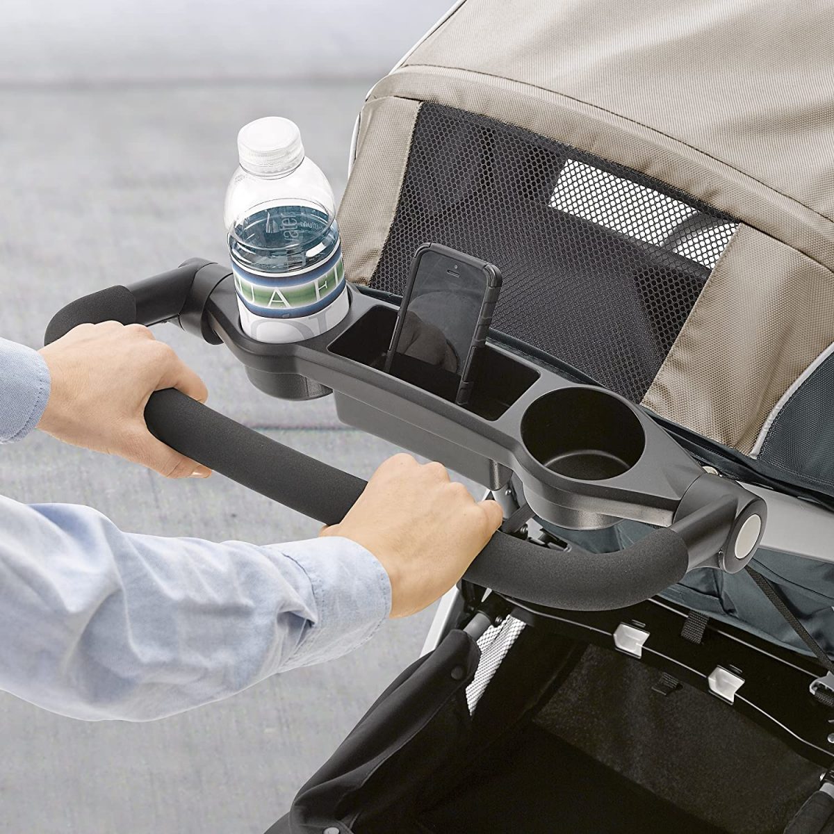 A stroller with cup holder on the handle